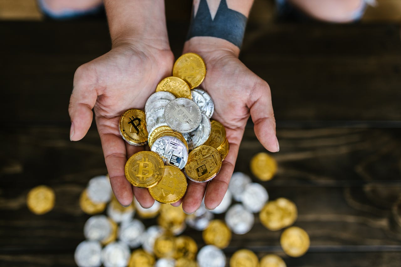 Services High angle of hands holding gold and silver cryptocurrency coins, symbolizing digital wealth.